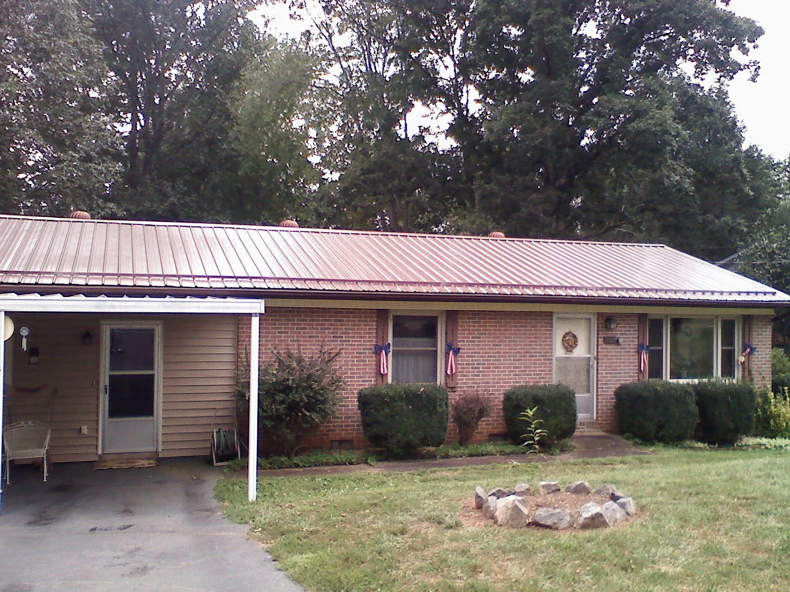 Bronze metal roof and carport on a brick ranch home — Roof Repair work by our crew in Lisle